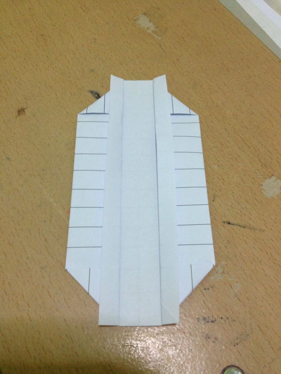 Fold the inner edges away from each other along with the previous creases.