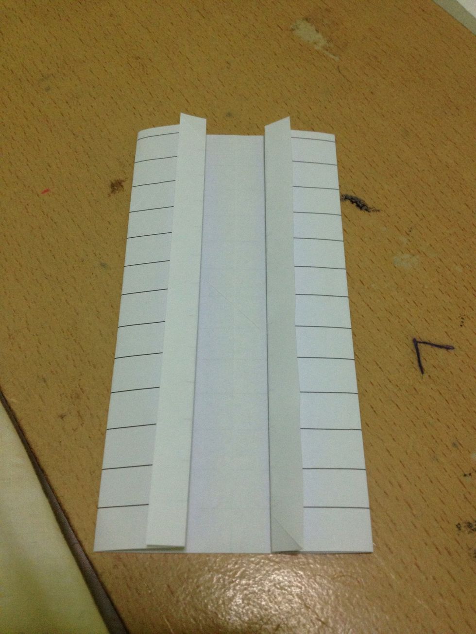 Fold the inner edges away from each other and unfold.