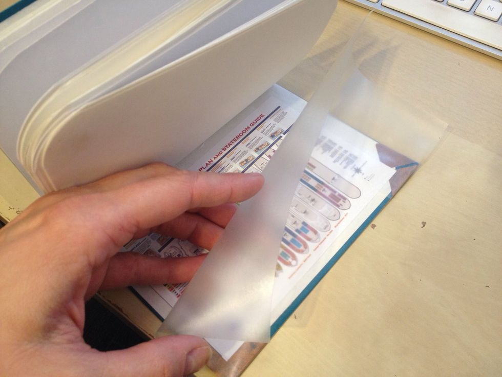 Fold the large flap of con-tac paper over to cover the inside of the book cover.