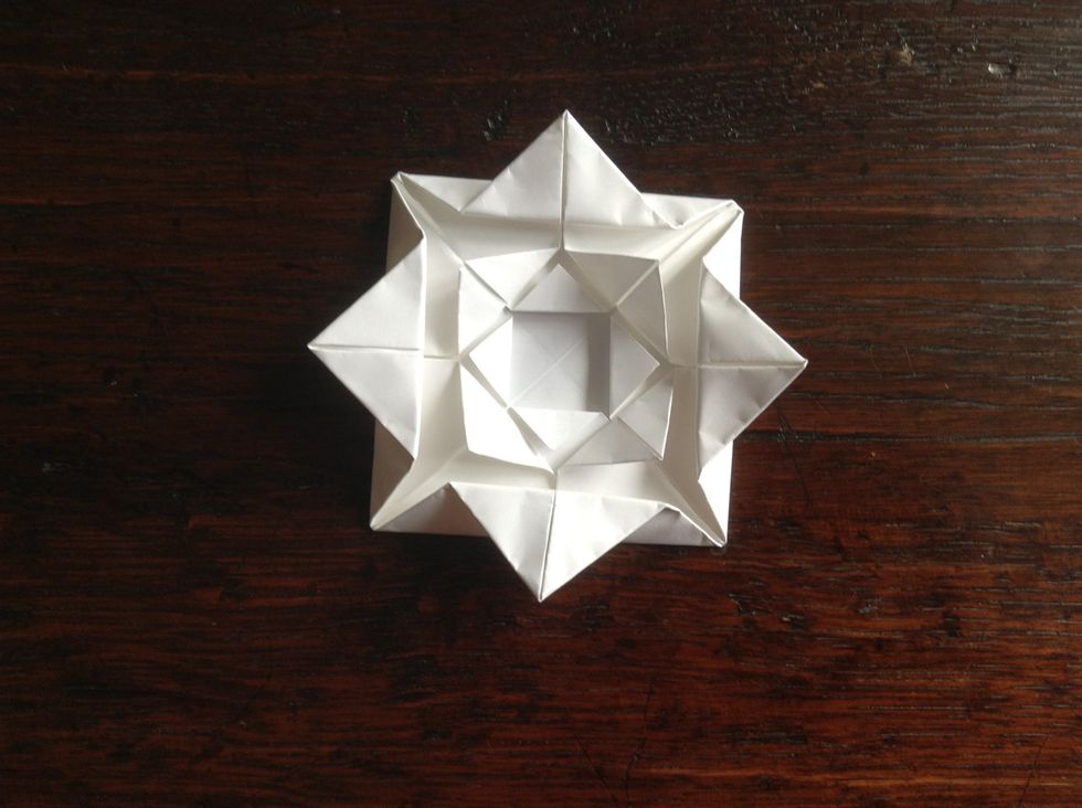 Fold the last layer of corners that are in the middle to make the last layer of petals.