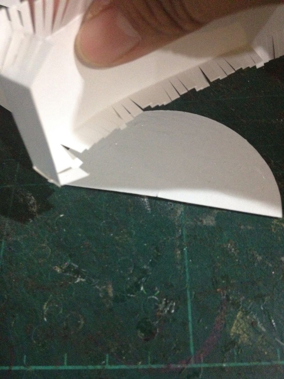 Fold the left and right. Now take the semi round and start to stick the left and right using glue. Remember to stick it at the round edge.