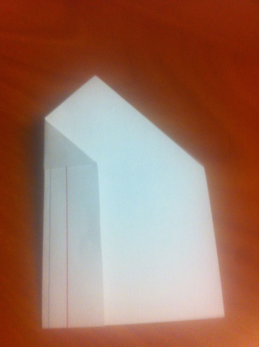 Fold the left edge into the middle of the card (as shown). Use the other side of the card as a guide. The new left edge shouldn't pass the tip of the triangle on the other side. Repeat for right edge.