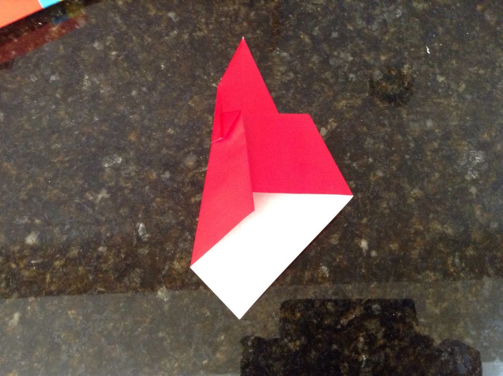 Fold the left part in a oblique way from the center of the top left edge to the center of the bottom.