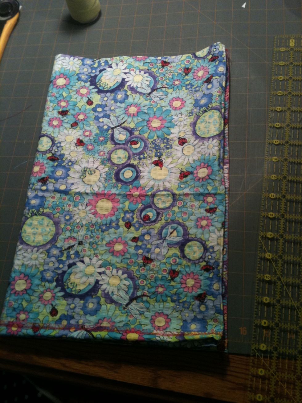 Fold the left to the right like this- now the fabric is four thick, with a seam and a fold on top of each other on the right.