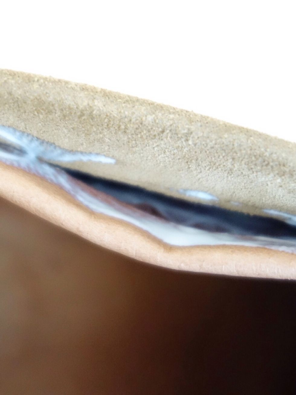 Fold the lining in so that it is slightly lower than the outside fabric. Add Mod Podge to seal the lining to the outer fabric.