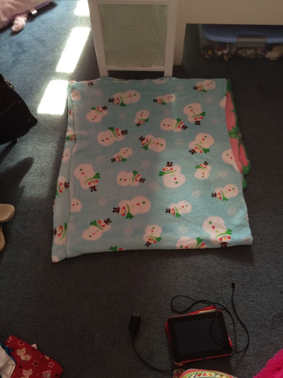 Fold the next blanket in half then place it on top of the first blanket for comfort. You should have extra hanging over so just fold it over until it touches the bottom blanket