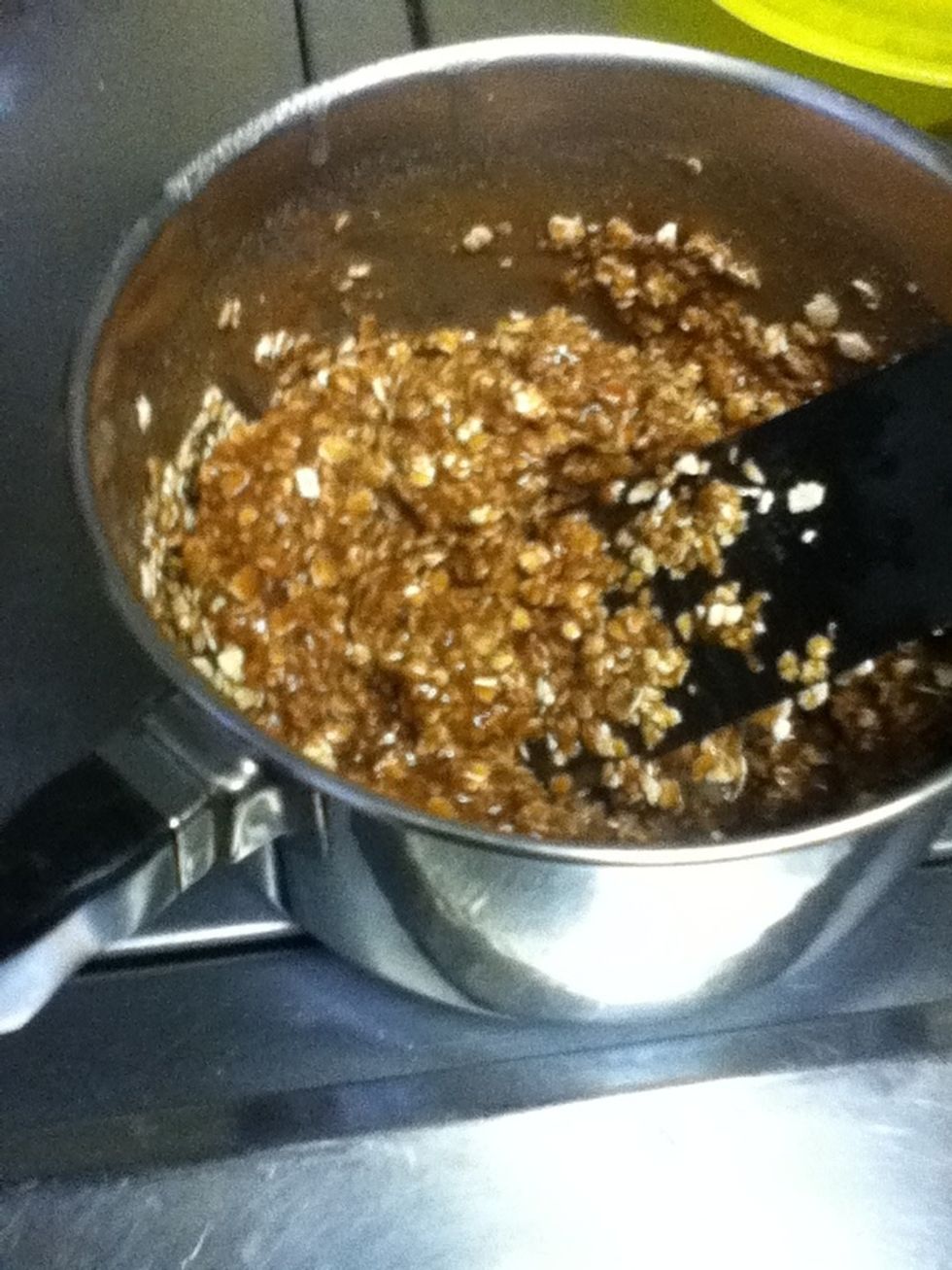 Fold the oats over the chocolate to cover them in chocolate.