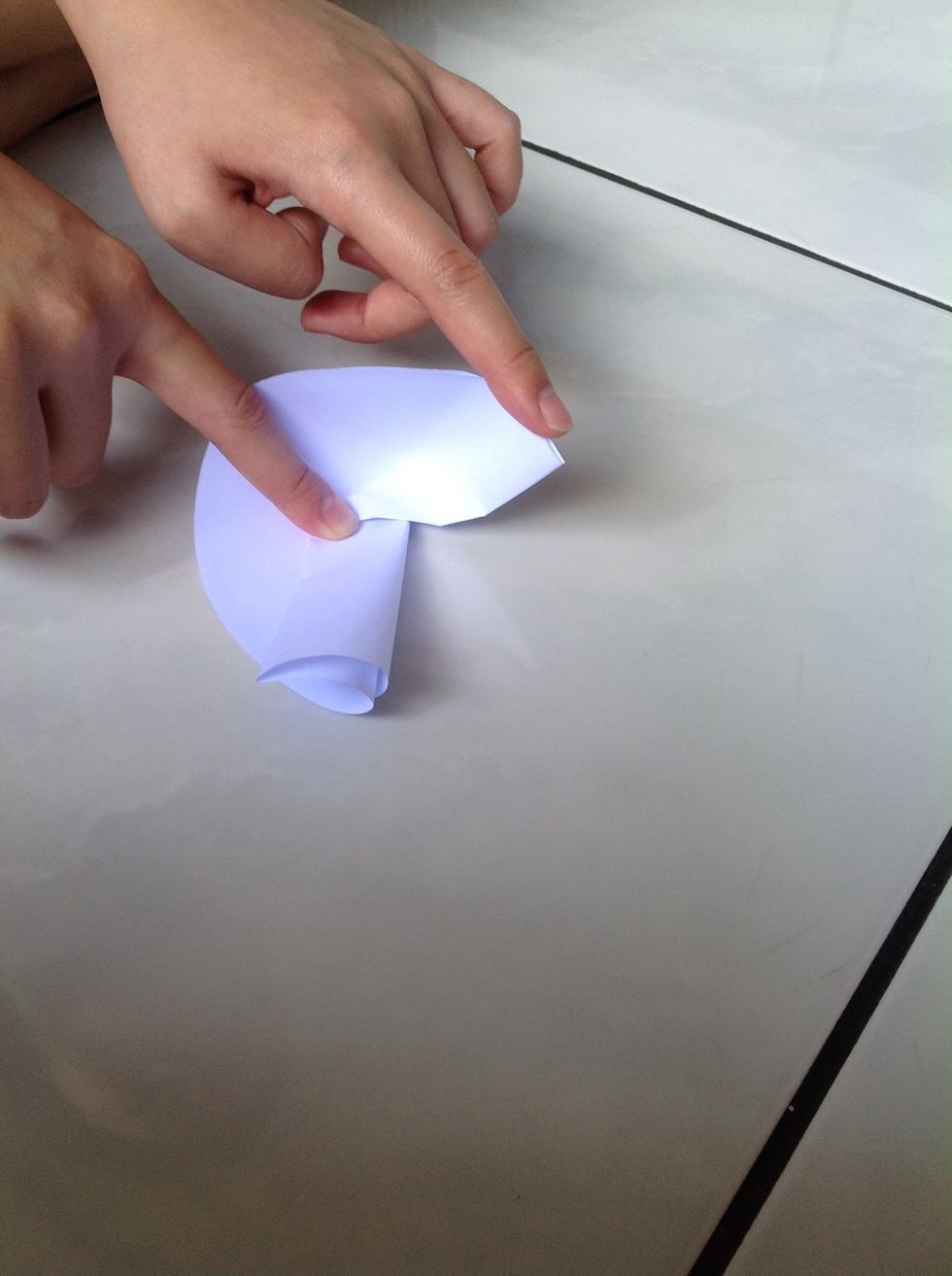 Fold the paper 90 degree upwards using your two index fingers,creating a right angled triangle on the paper