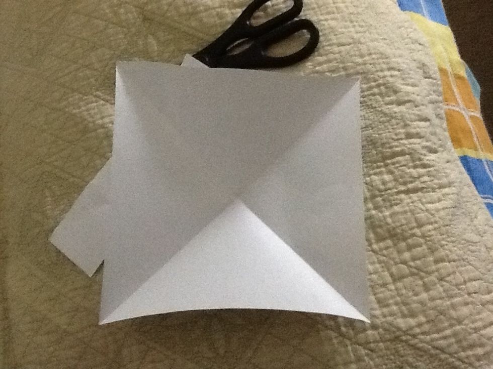 Fold the paper along both the diagonals.