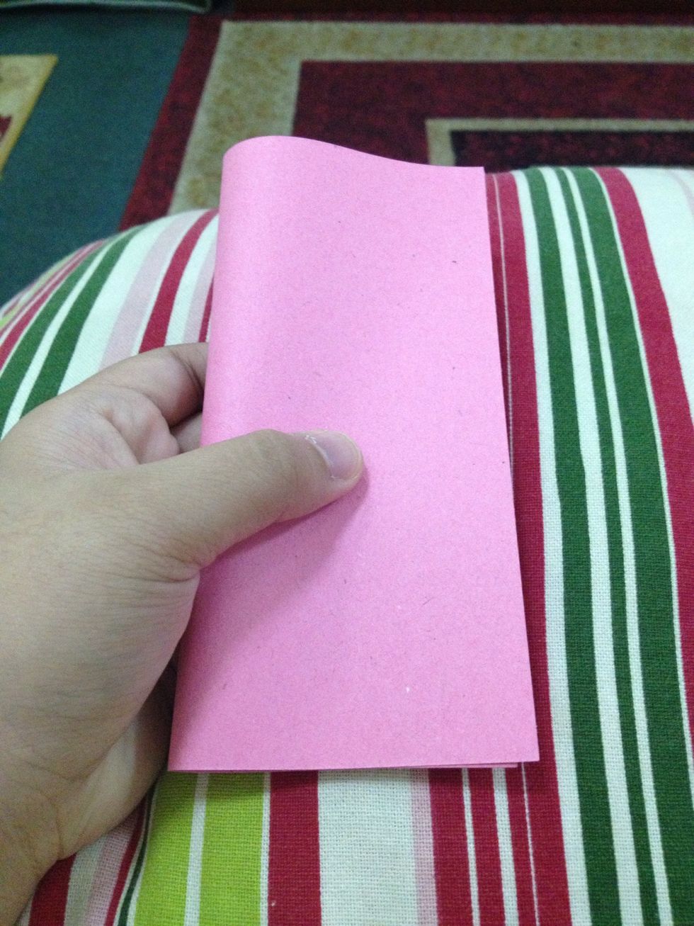 Fold the paper in half and unfold.