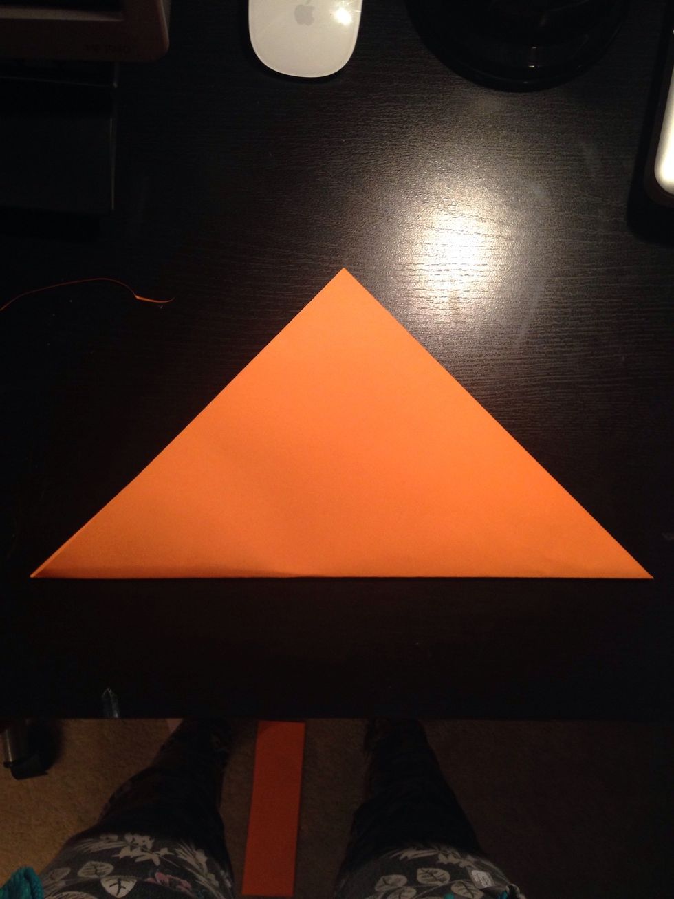 Fold the paper in half diagonally.