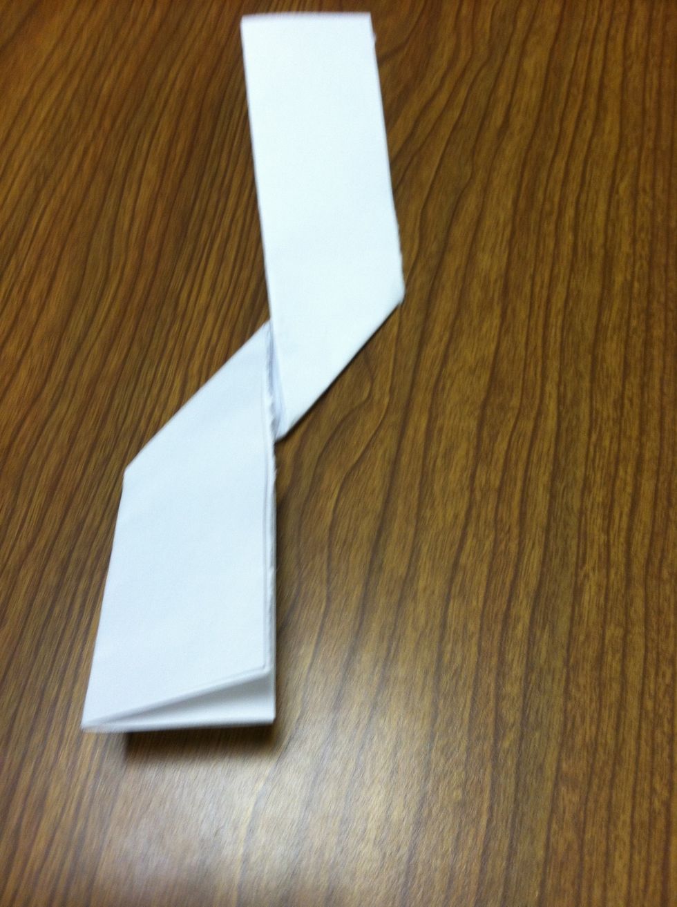 Fold the paper in half hamburger style again, then fold the right side up and the left side down.