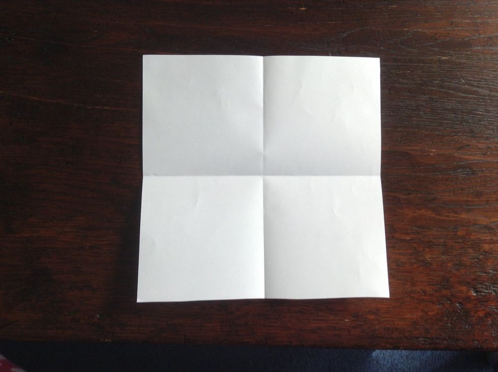 Fold the paper in half the other way and unfold to make a crease.