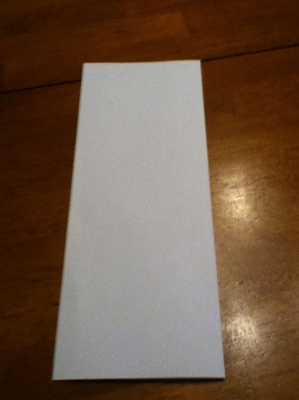 Fold the paper in half.