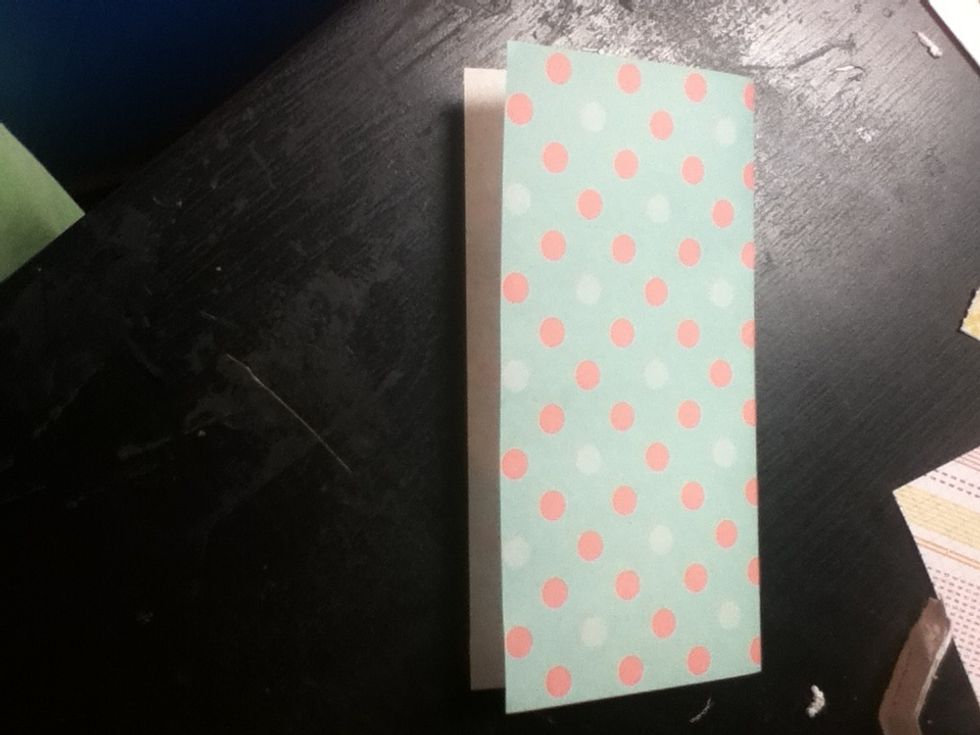 Fold the paper in half.