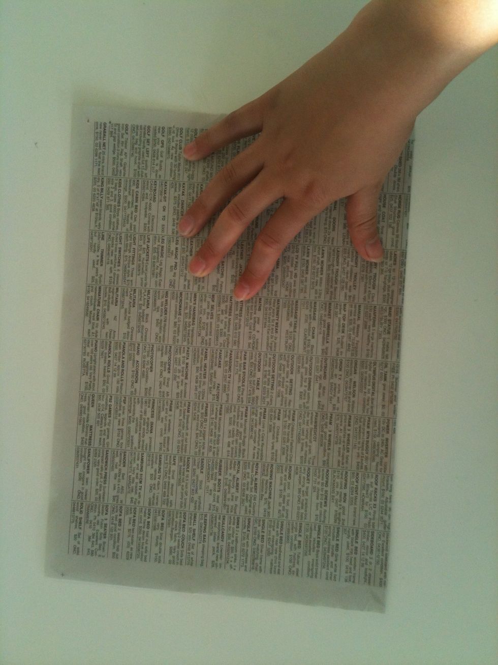 Fold the paper in half.