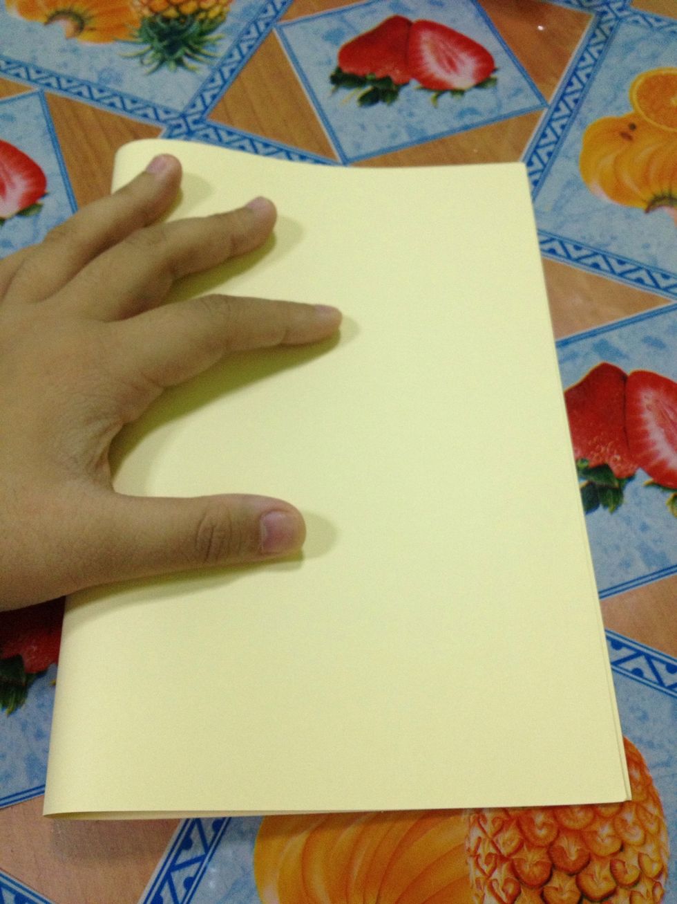 Fold the paper in half.