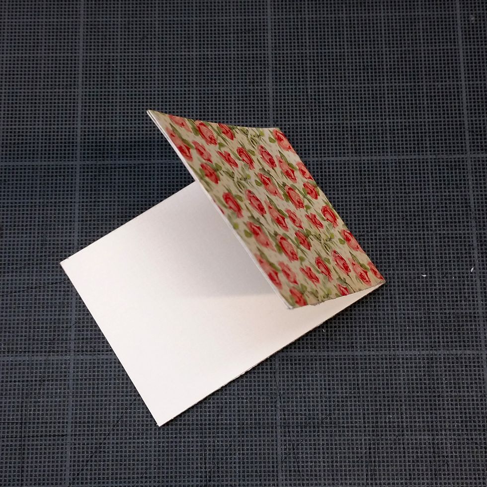 Fold the paper in the middle, so that you can open it and write inside.