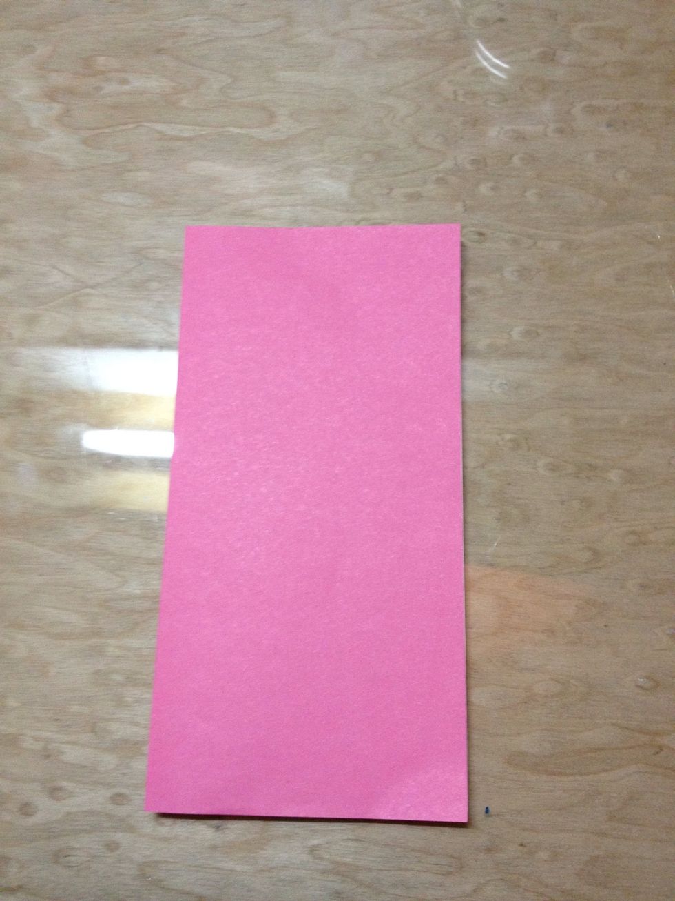 Fold the paper into half.