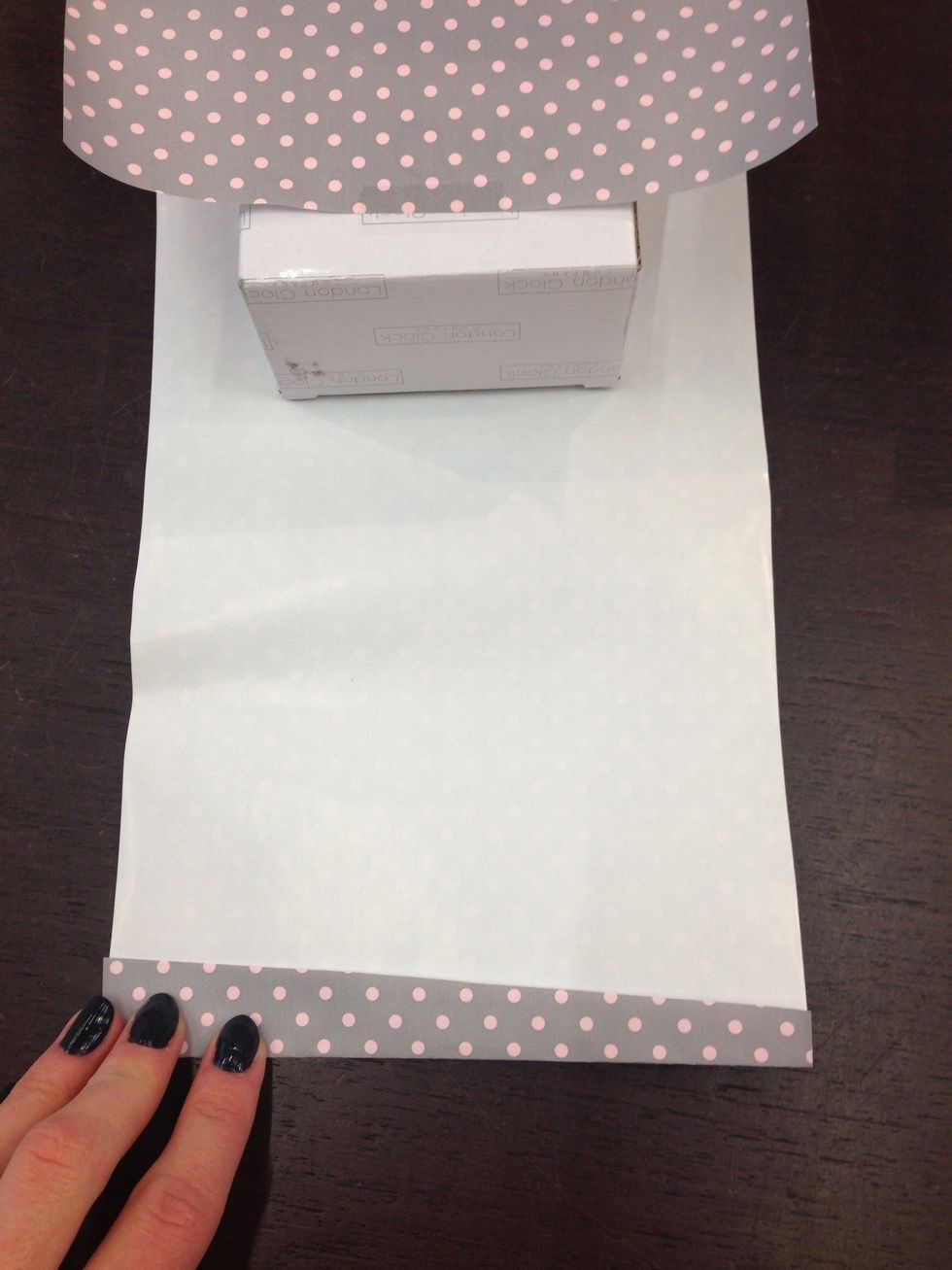 Fold the paper like this, just a little bit. The reason why you should do this is because the paper wont be crooked