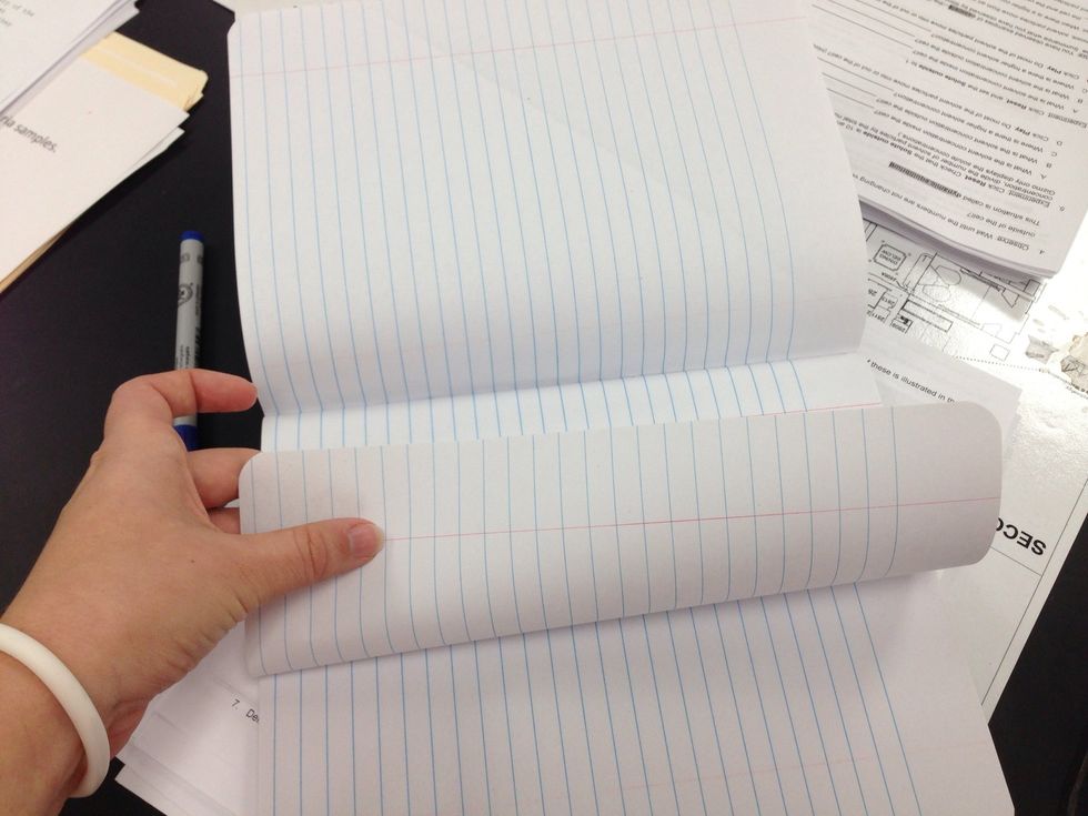 Fold the paper up to the binding