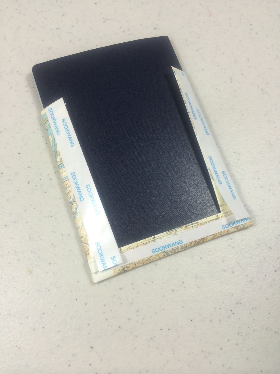 Fold the papers around the passport as shown then add Scor-Tape.