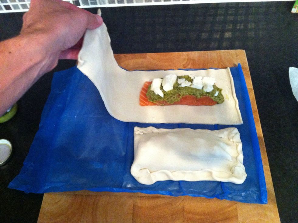 Fold the pastry sheet over the fillet as shown and pinch the edges together