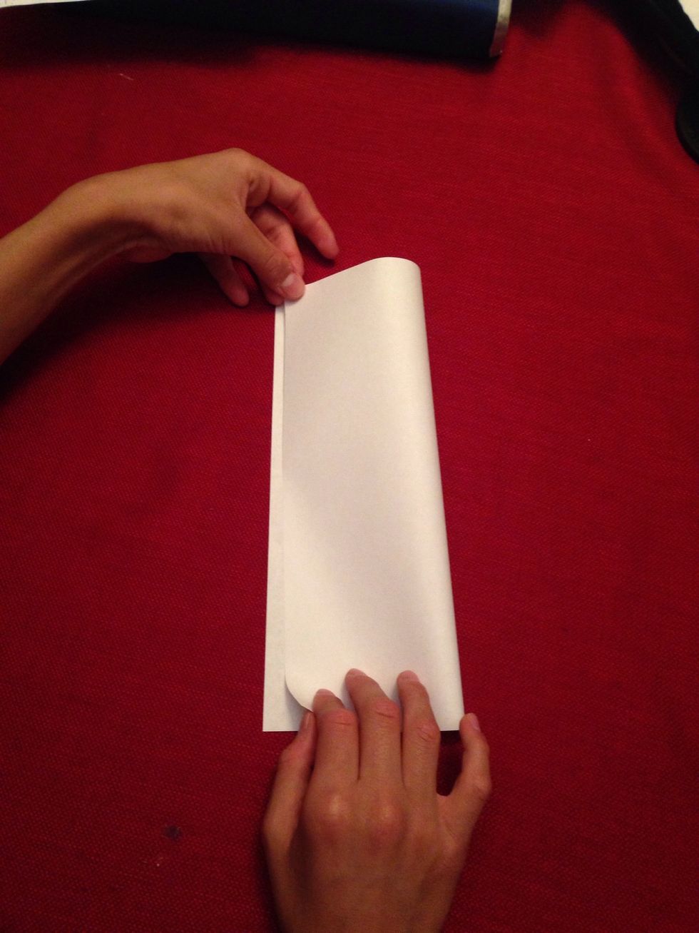 Fold the piece of paper from left to right in half.