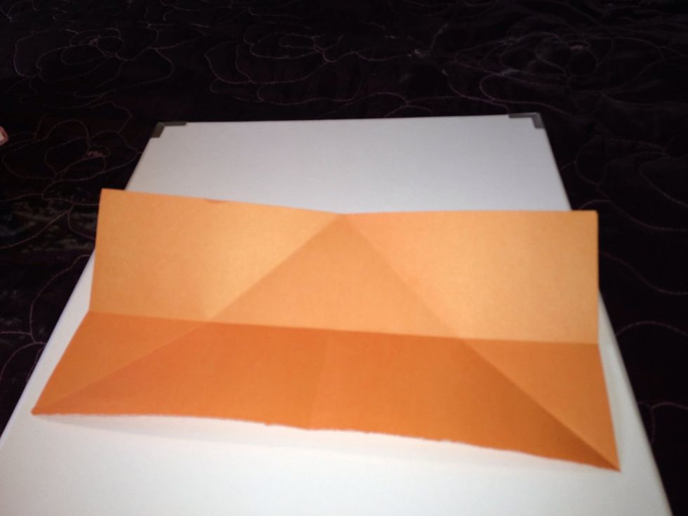Fold the piece of paper length way across the middle