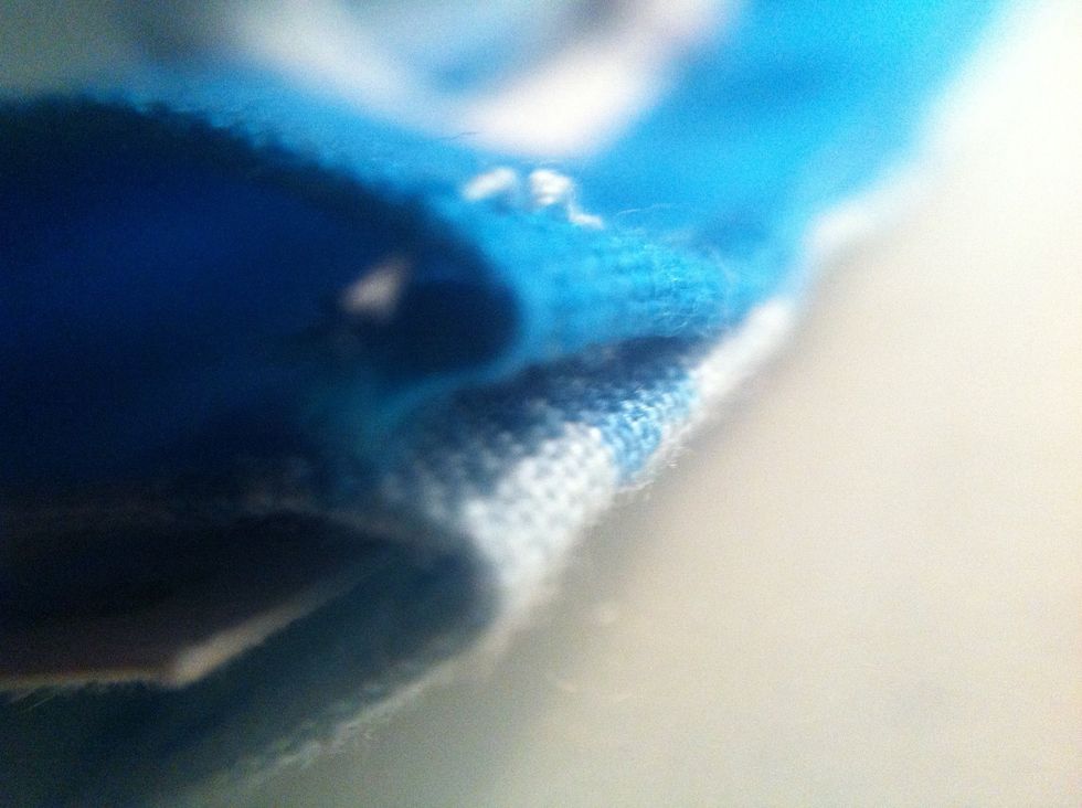 Fold the plain fabric inwards and iron. Do this with the patterned fabric too, making sure they line up together. Do this for all the sides. I