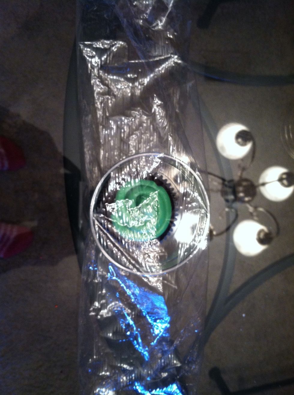 Fold the plastic wrap "hot dog style" over the plastic cup.