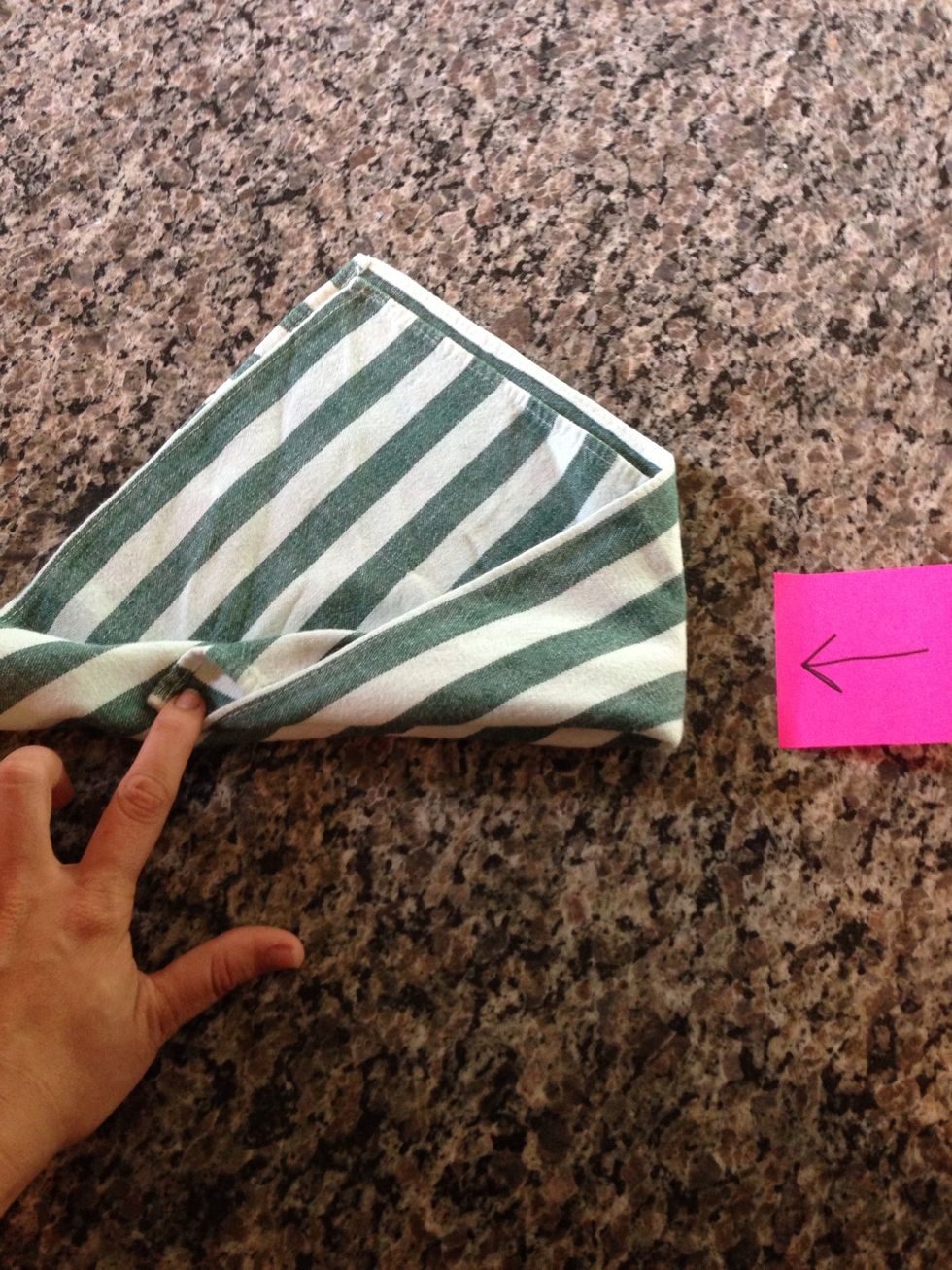 Fold the point of the right side in towards the middle.