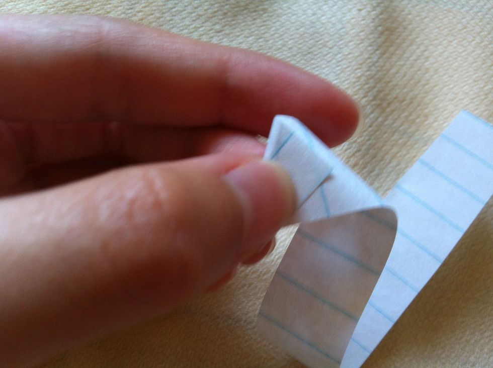 Fold the rest of the strip back so that it makes an equilateral triangle