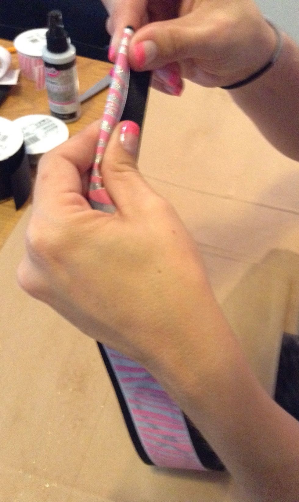 Fold the ribbon in half joining the 2 ends firmly an then folding the in half lengthwise at the ends.