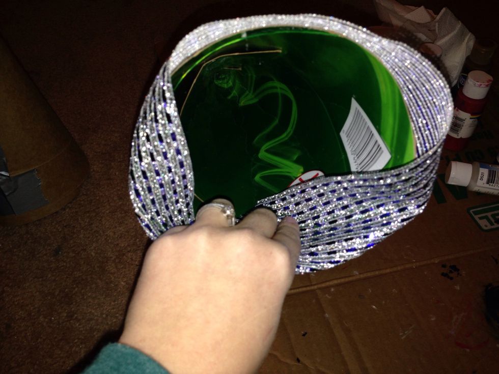 Fold the ribbon to the inside of the cone and hot glue it down
