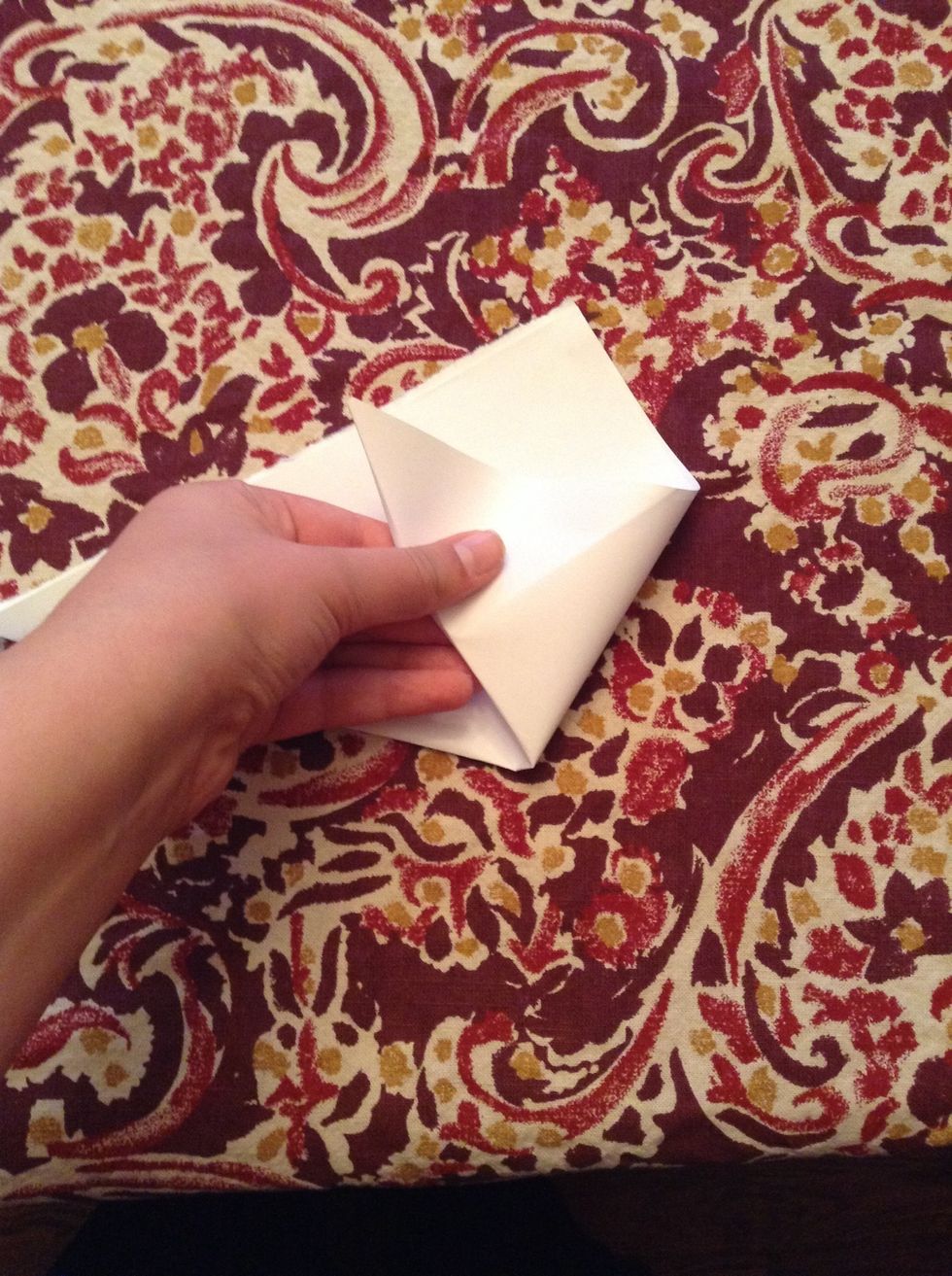 Fold the right bottom corner to the edge like shown.