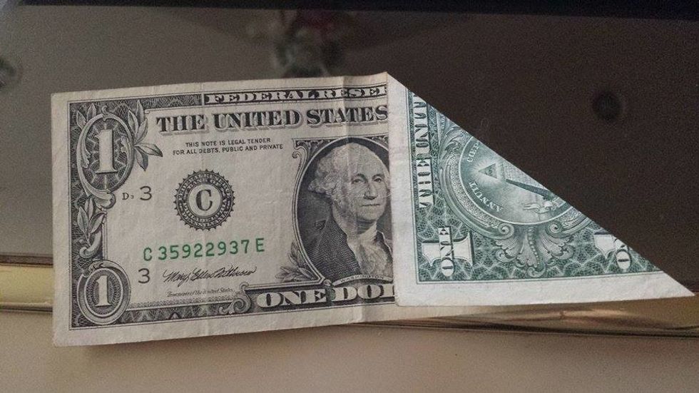 Fold the right corner into a triangle.