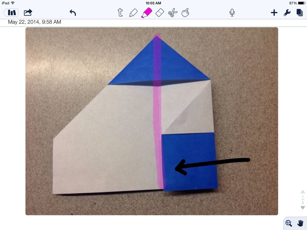 Fold the right side of the paper to the center line.