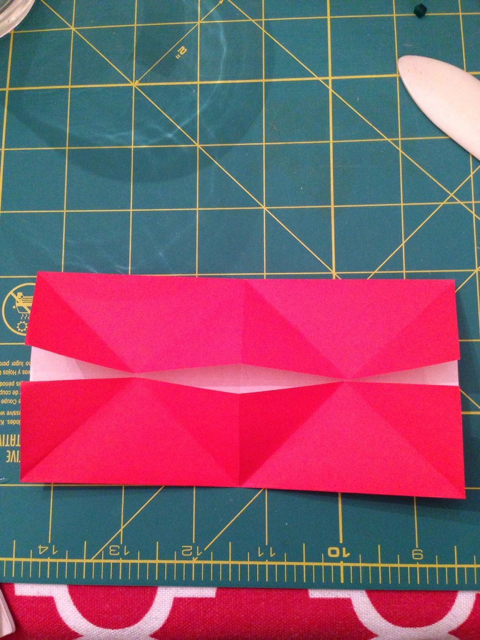 Fold the short edges inward, lining the up with the intersection of the diagonal creases. Unfold.