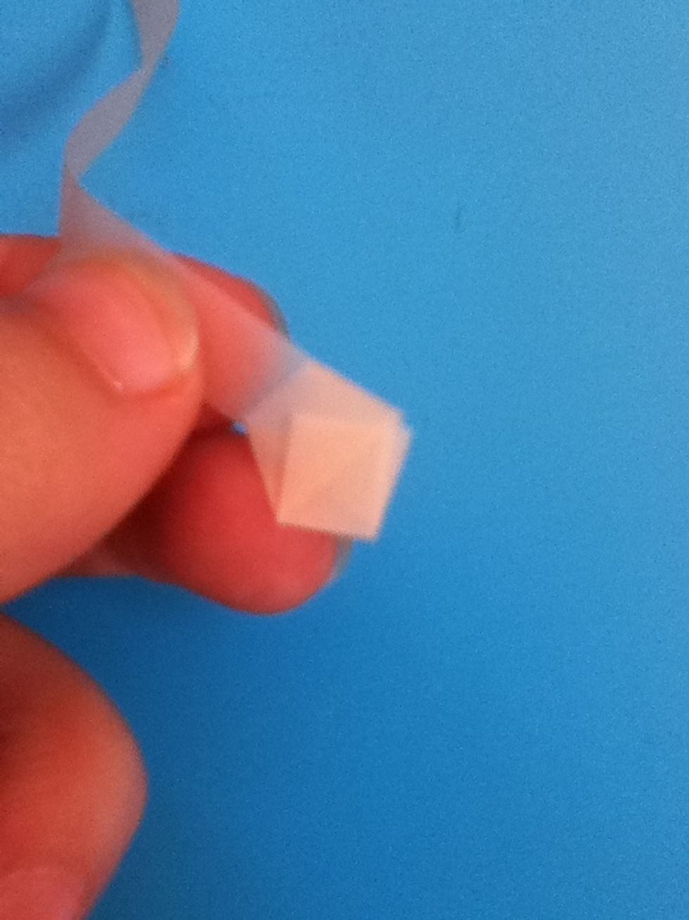 Fold the short tail up against the knot. If it is too long, just trim it a little.