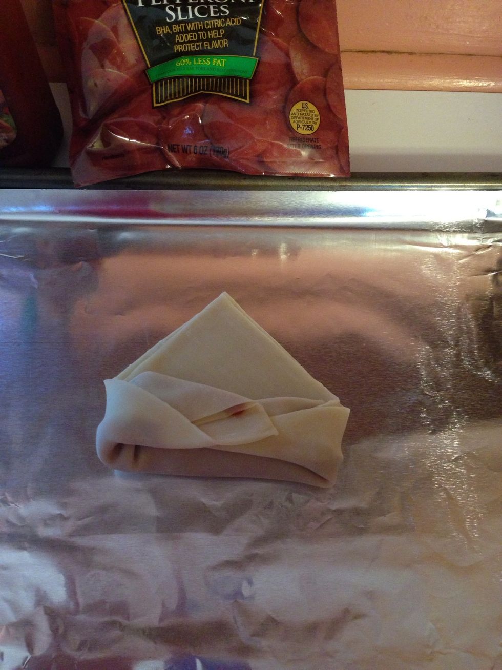 Fold the side corners in and roll. This is my first attempt at using egg roll wrappers so bear with me. \ud83d\ude04