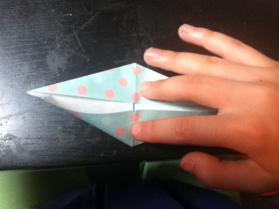 Fold the sides inward on the creases that are already there.