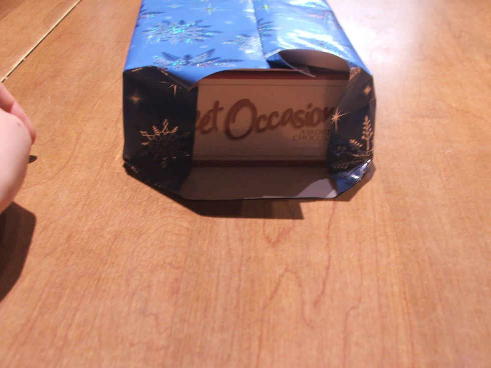Fold the sides toward the end of the box.