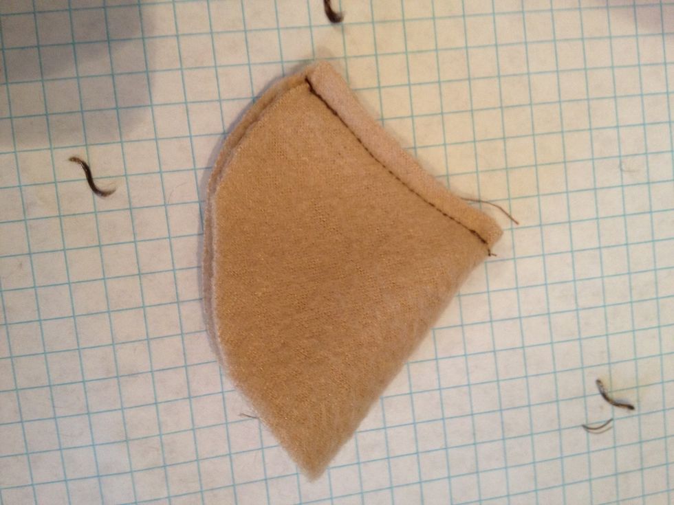 Fold the small half moon in half and sew along the straight edge.