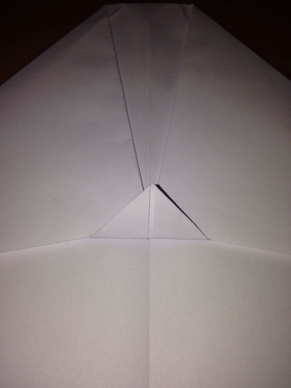 Fold the small triangle on top of the two corners to hold them down
