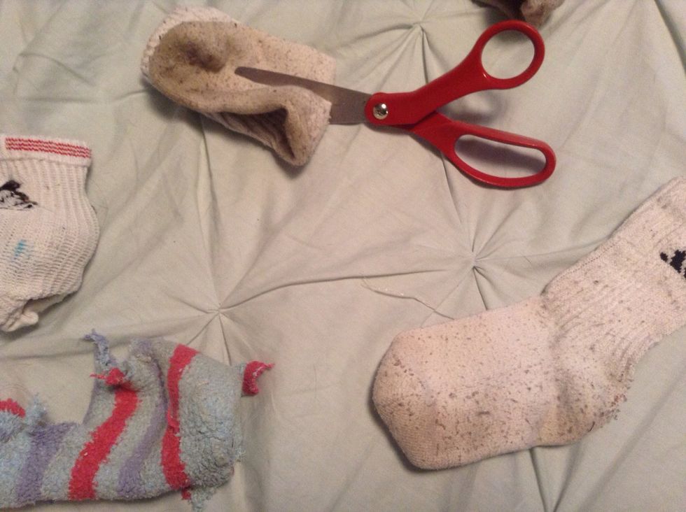 Fold the socks in half and cut a hole through all socks. Make your own patterns but the more you tie the more fun.