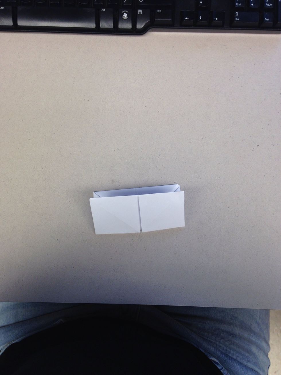 Fold the square in half.