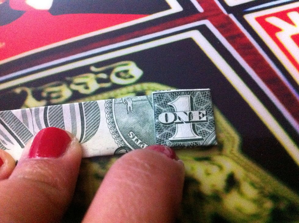 Fold the square piece to the back to make a crease line to the right side of the 1.