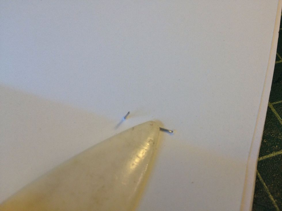 Fold the staple ends over inside the book.