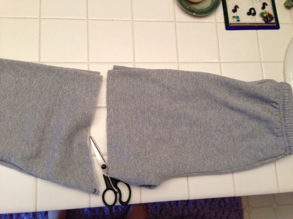 Fold the sweats and cut through the mark. Open them up and do one side at a time if you have weak scissors. ;)